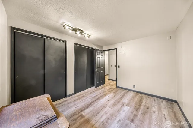 a view of a big room with closet and chandelier fan
