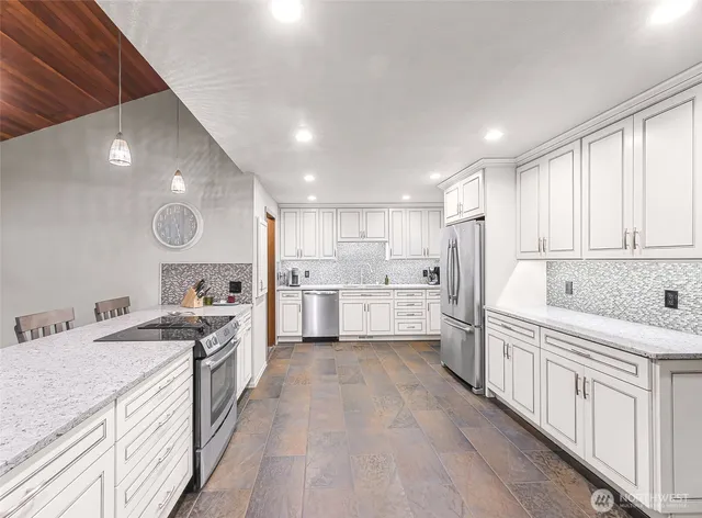 a kitchen with a sink stove and cabinets