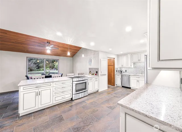 a kitchen with white cabinets and white appliances