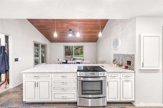 a kitchen with stove cabinets and window