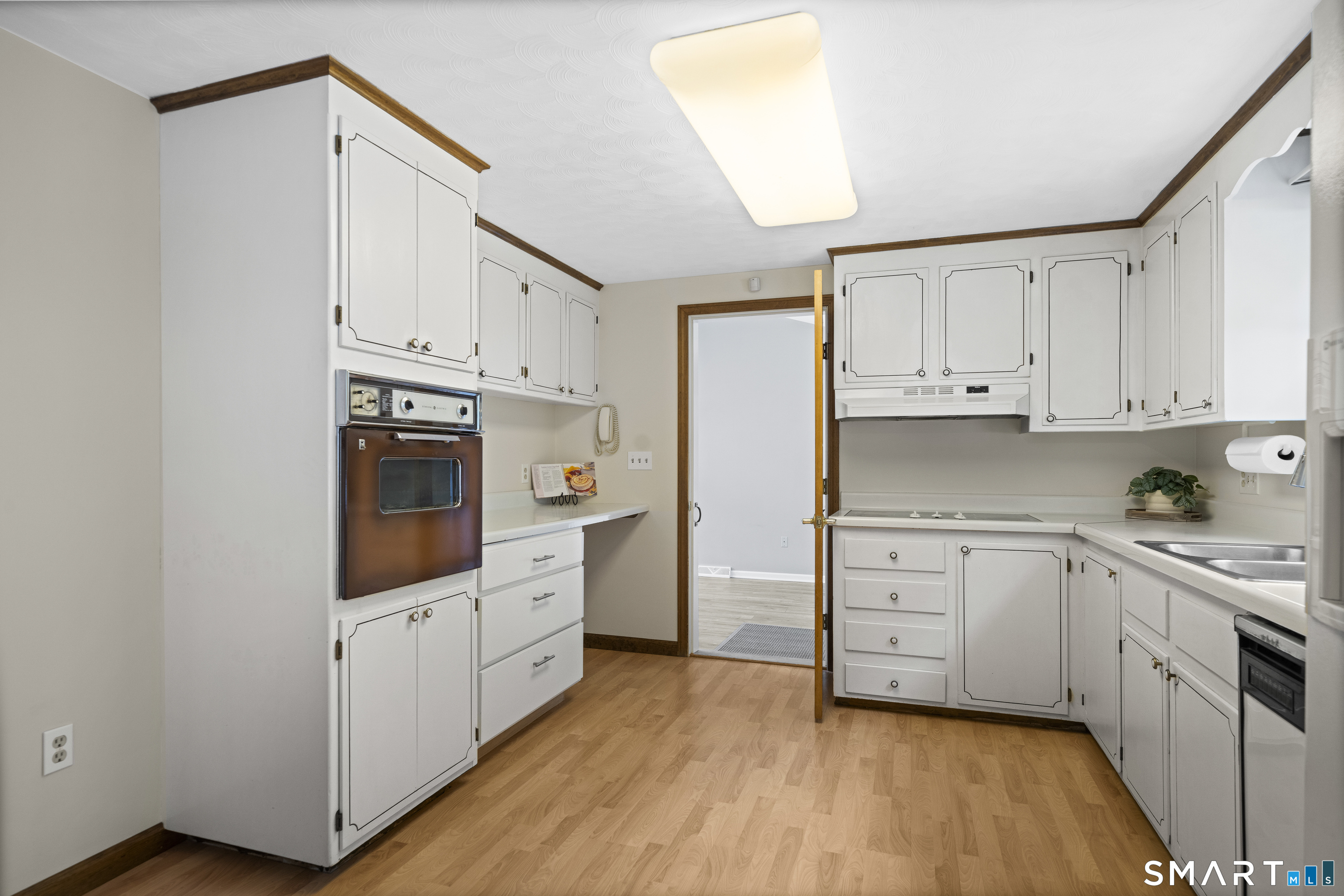 6 Cartier Road Enfield, CT 06082 - Photo 10 of 40 a kitchen with granite countertop white cabinets and white appliances