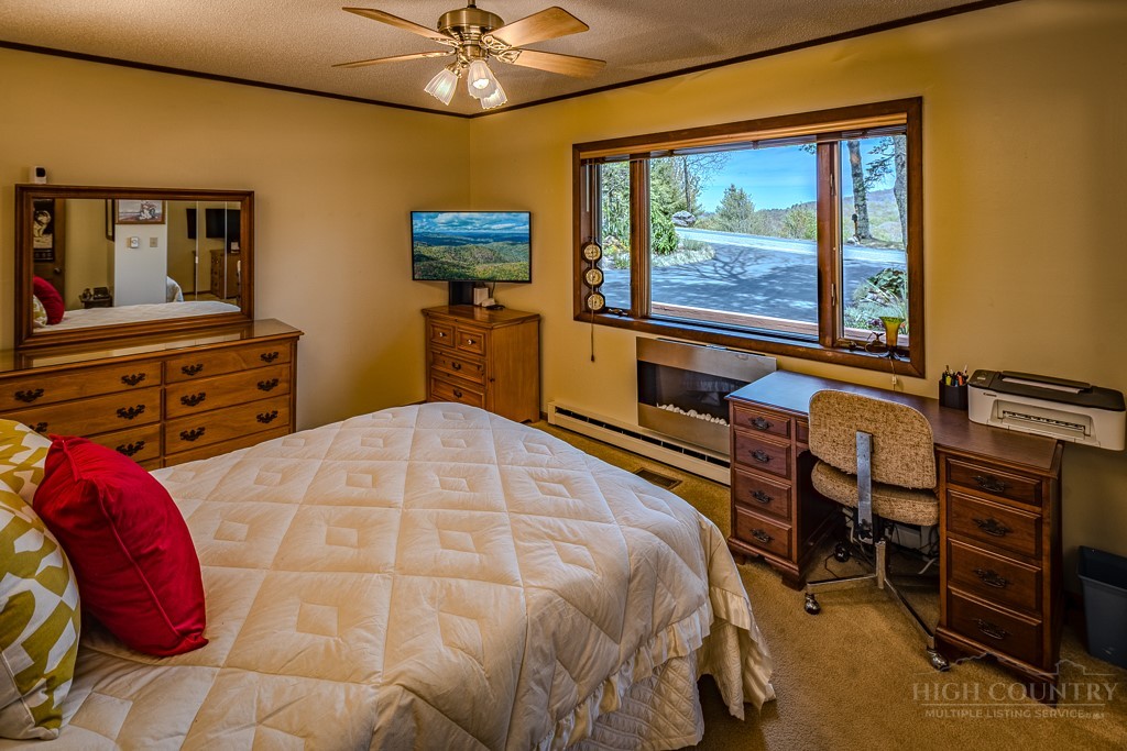 103-105 Upper Grouse Ridge Road Beech Mountain, NC 28604 - Photo 26 of 48 a bedroom with a bed and wooden floor