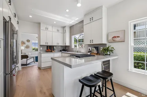 a kitchen with stainless steel appliances a refrigerator sink and cabinets