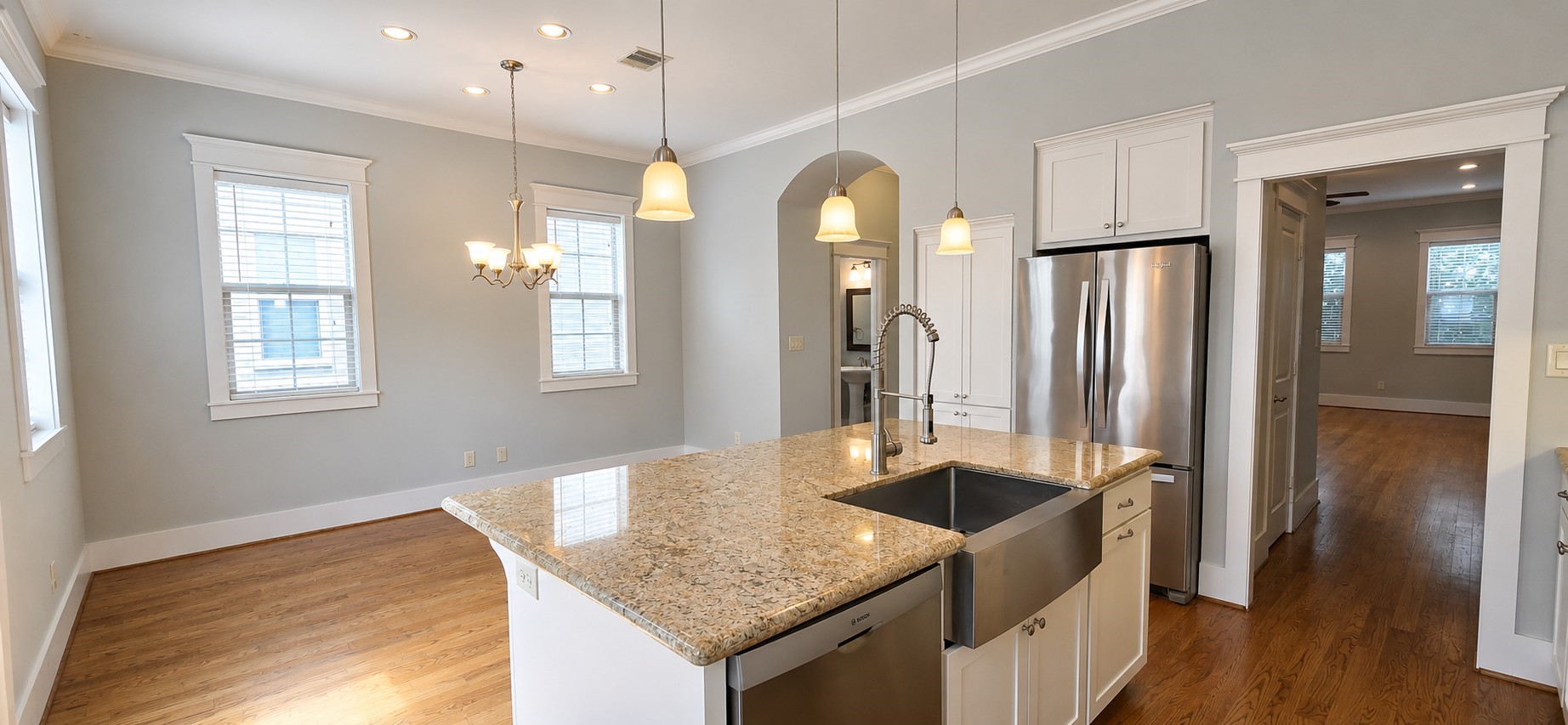 1117 Bonner Street Houston, TX 77007 - Photo 18 of 44 Kitchen includes a large island with a granite countertop, low-hanging accent lighting and a stainless steel dishwasher, farmhouse sink & refrigerator.