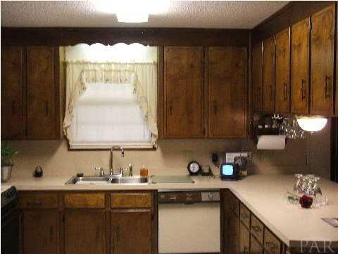 4839 Williams Road Pace, FL 32571 - Photo 17 of 17 LOADS OF CABINETS & COUNTER SPACE ~ PANTRY ~ BREAKFAST BAR ~ PLUS EAT N KITCHEN ~ NEW CERAMIC TILE