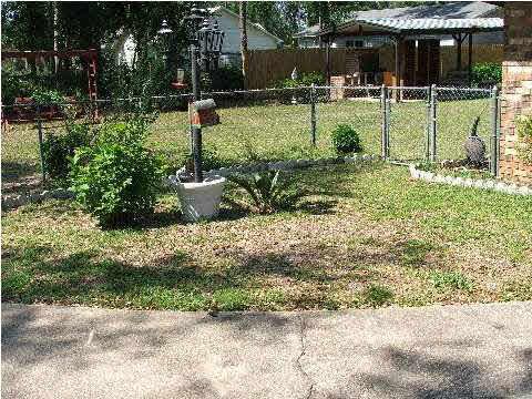 4839 Williams Road Pace, FL 32571 - Photo 10 of 17 ~ SIDE ENTRANCE TO BACKYARD ~ ONE SINGLE GATE AND TWO DOUBLE GATES TO REAR ~