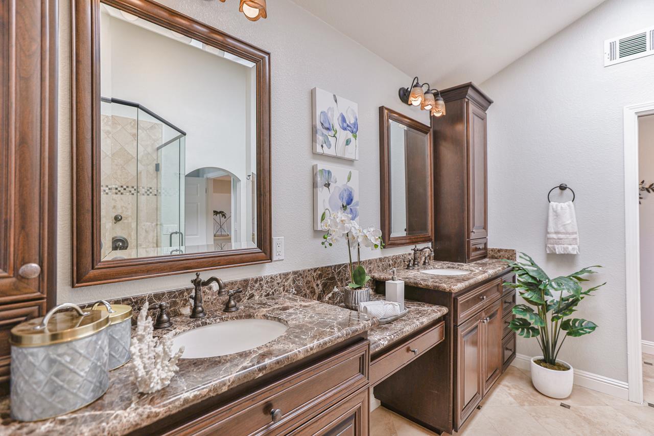 220 Rio Grande Court San Ramon, CA 94582 - Photo 24 of 33 a bathroom with a granite countertop sink a mirror and a shower