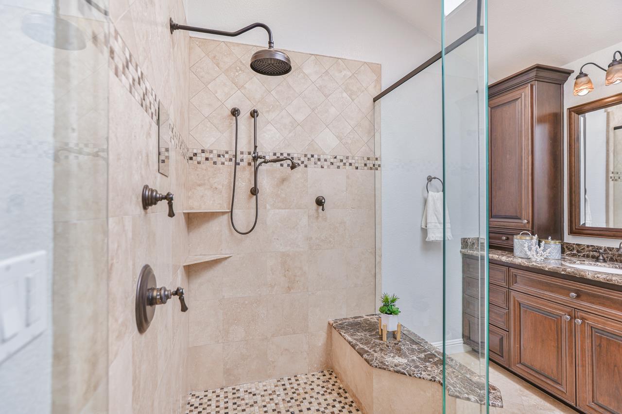 220 Rio Grande Court San Ramon, CA 94582 - Photo 26 of 33 a bathroom with a granite countertop shower a sink and a mirror