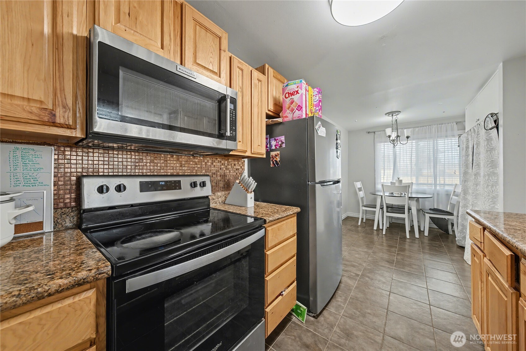 160 G Street Northeast Ephrata, WA 98823 - Photo 16 of 34 a kitchen with granite countertop a stove top oven microwave and refrigerator