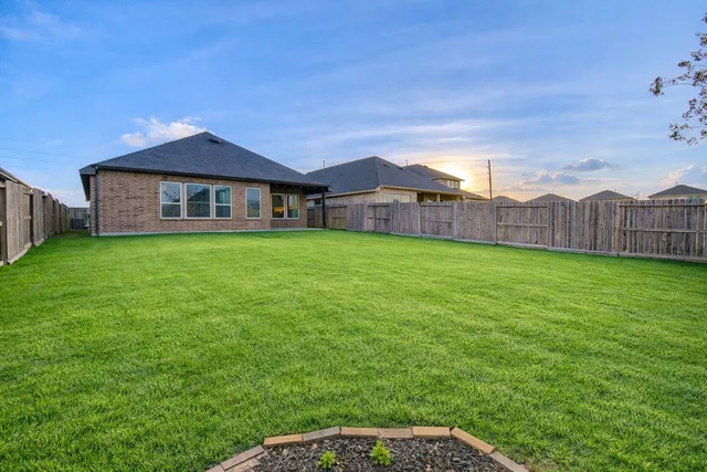 a view of a house with a yard and a porch