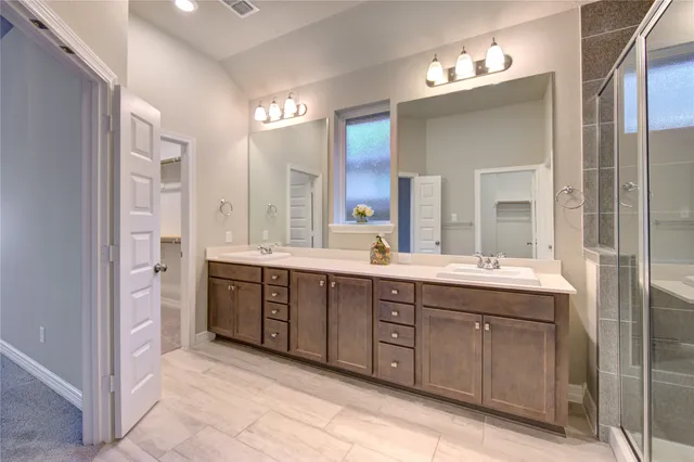 a spacious bathroom with a double vanity sink mirror and double