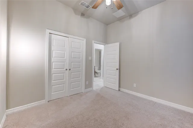 an empty room with closet area