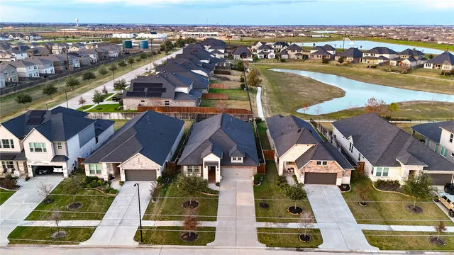 an aerial view of residential houses with outdoor space and ocean view