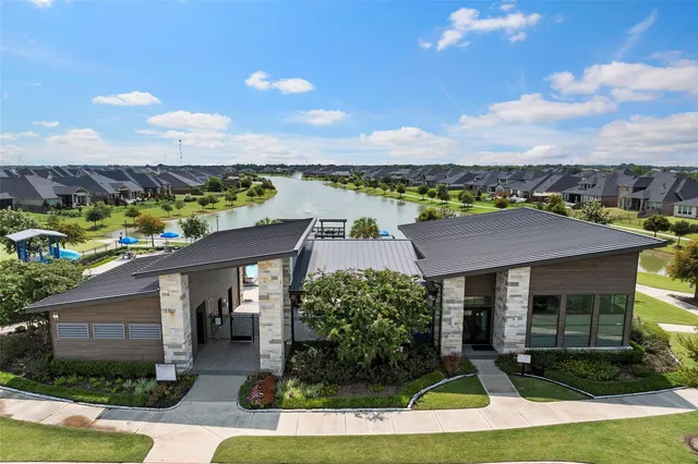 a aerial view of a house with a yard and potted plants