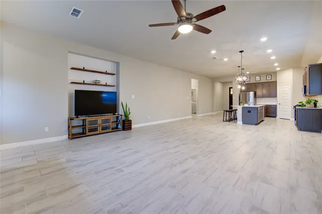 a view of a livingroom with furniture and a flat screen tv