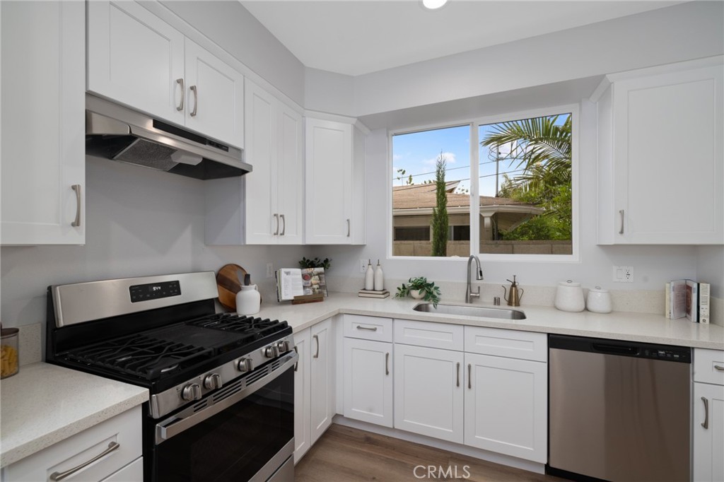 11237 Gladhill Road, Unit 6 Whittier, CA 90604 - Photo 15 of 34 a kitchen with cabinets appliances a sink and a window