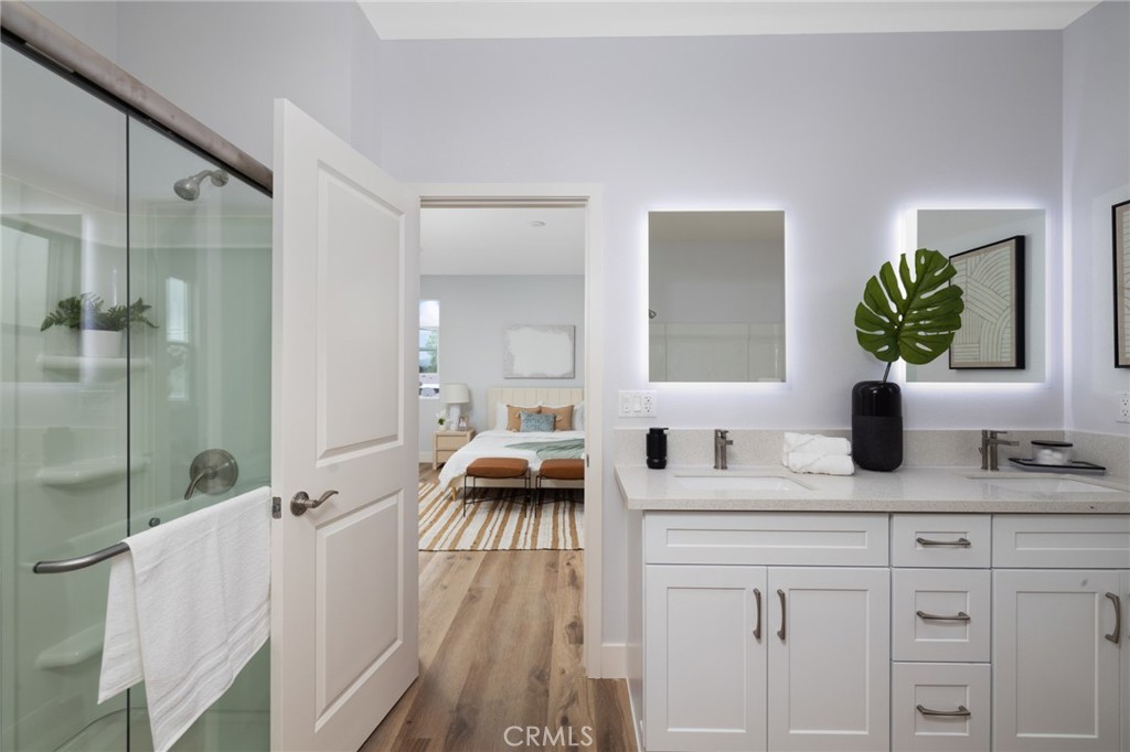 11237 Gladhill Road, Unit 6 Whittier, CA 90604 - Photo 24 of 34 a en suite bathroom with a double vanity sink a mirror and shower