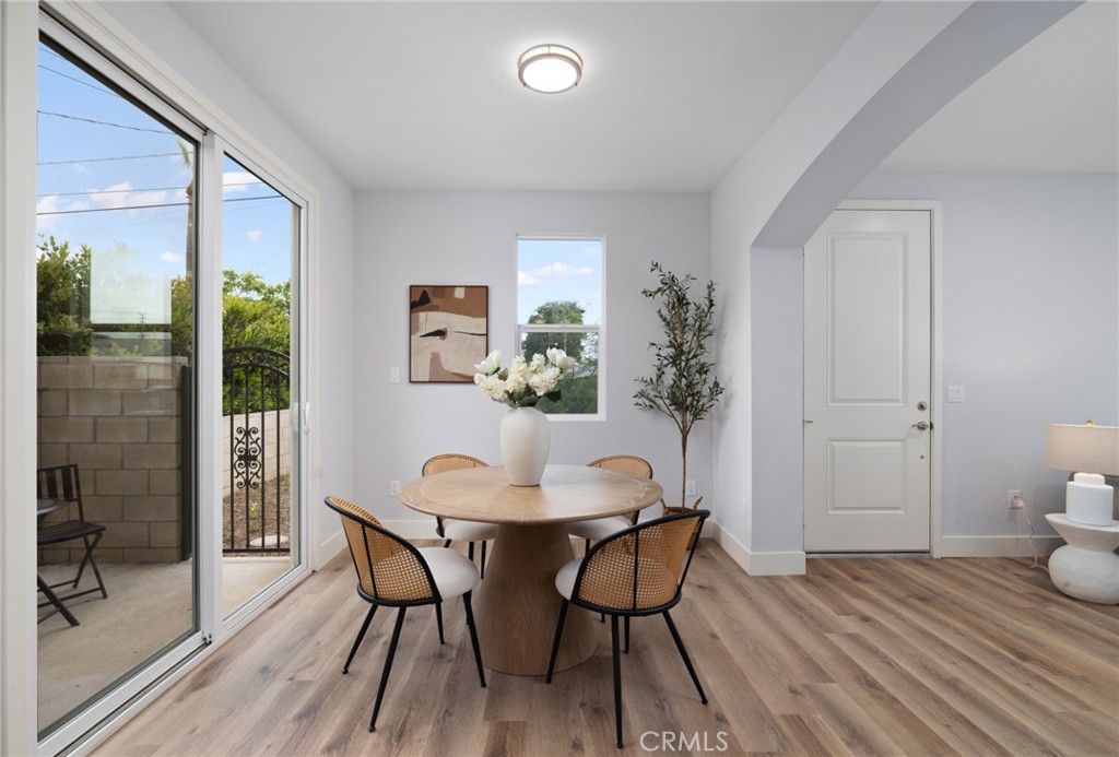 11237 Gladhill Road, Unit 6 Whittier, CA 90604 - Photo 9 of 34 a view of a dining room with furniture and wooden floor