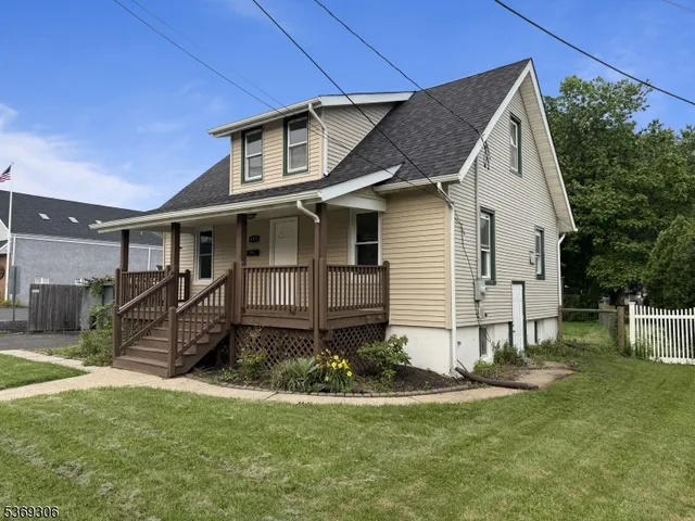 a view of a house with a yard and sitting area
