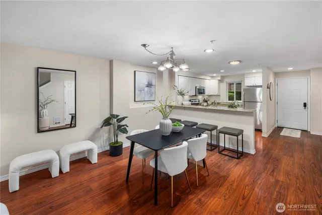 a kitchen with stainless steel appliances granite countertop a refrigerator sink and stove