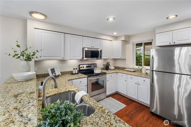 a kitchen with a sink stove and cabinets