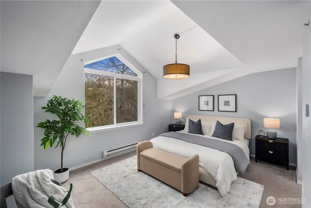 a bedroom with furniture and a potted plant