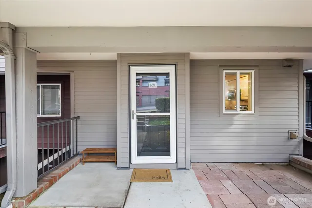 a view of a hallway with wooden floor and furniture