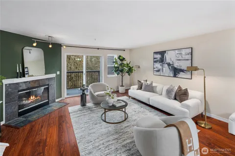 a living room with furniture a window and a fireplace