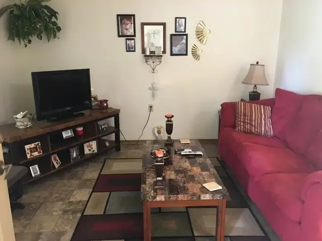 a living room with furniture and a flat screen tv