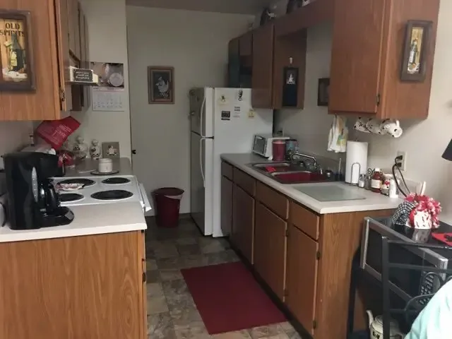 a kitchen with a sink stove and cabinets