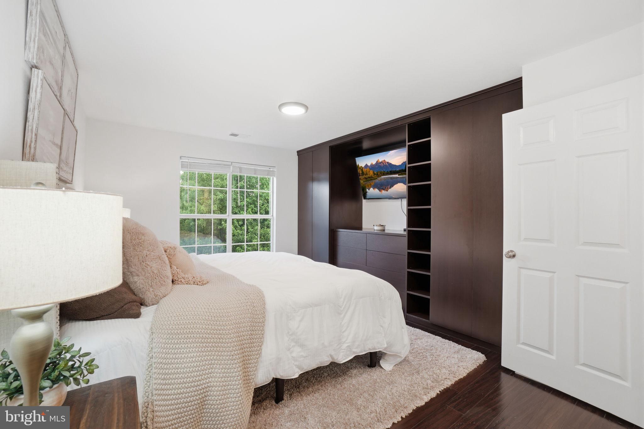 20960 Timber Ridge Terrace, Unit 303 Ashburn, VA 20147 - Photo 13 of 32 Spacious bedroom with custom storage