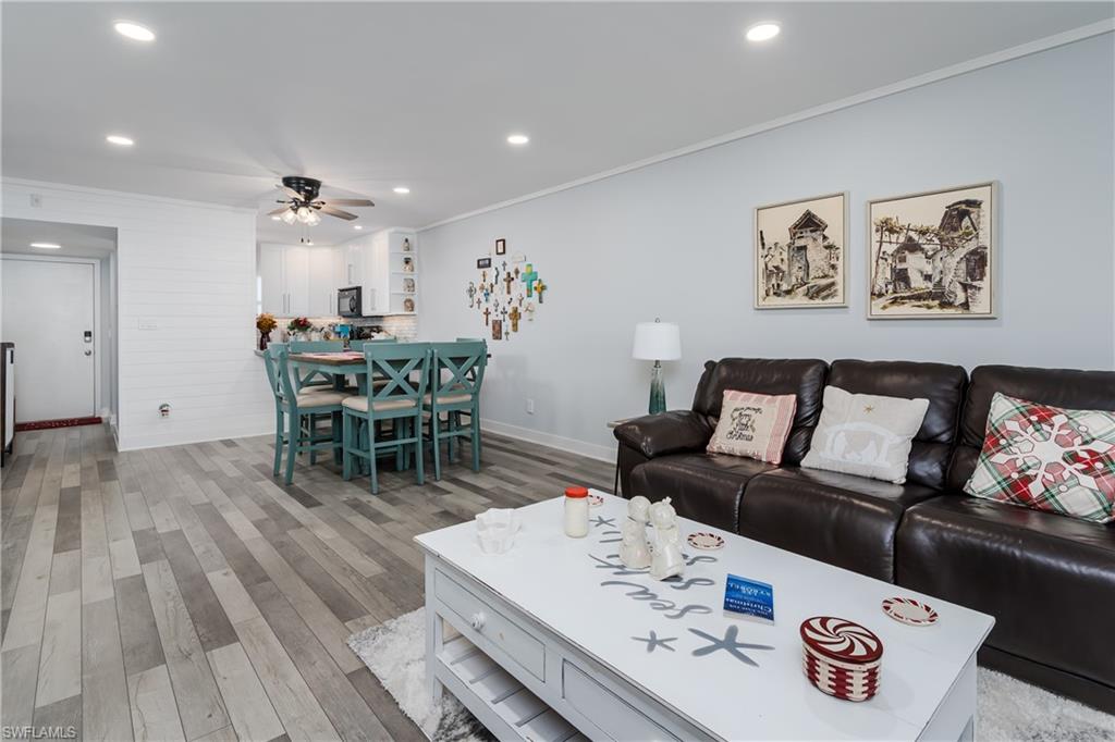 5499 Rattlesnake Hamm Road, Unit 304A Naples, FL 34113 - Photo 1 of 30 a view of a dining room with furniture and wooden floor