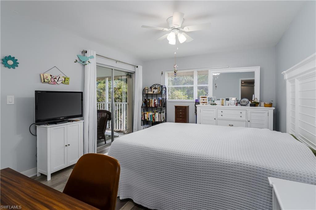5499 Rattlesnake Hamm Road, Unit 304A Naples, FL 34113 - Photo 16 of 30 a bedroom with a bed and a flat screen tv