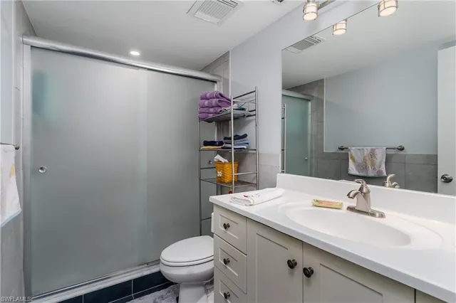 a bathroom with a sink mirror vanity and toilet