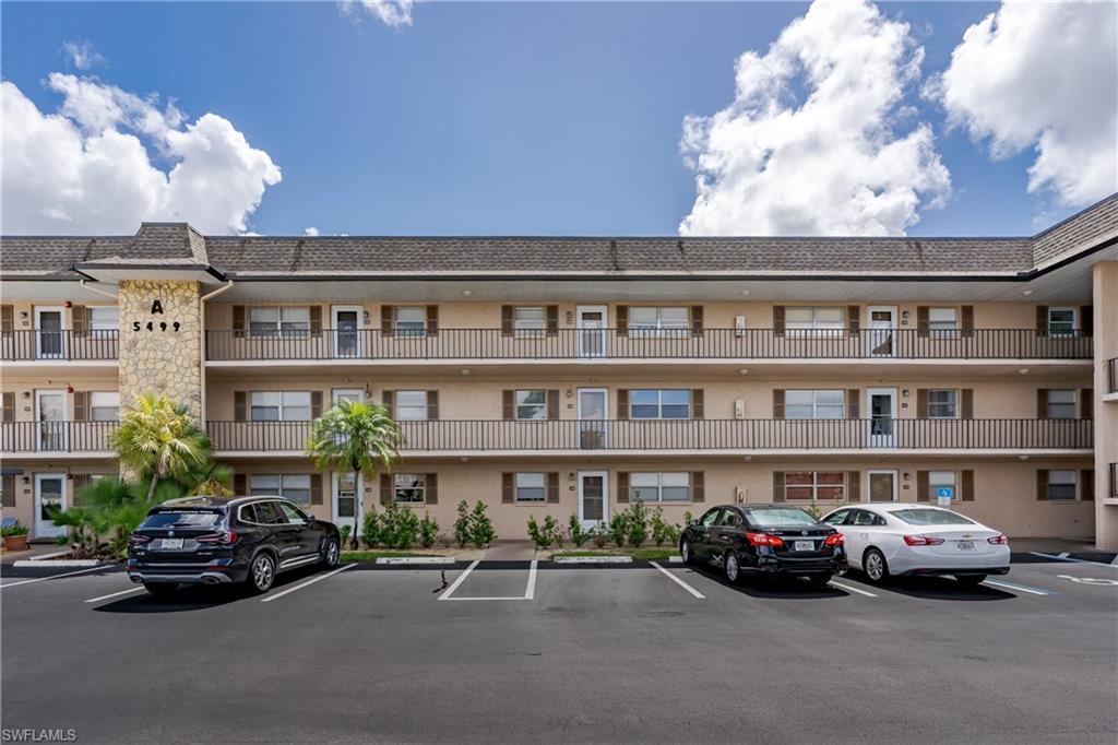 5499 Rattlesnake Hamm Road, Unit 304A Naples, FL 34113 - Photo 26 of 30 a car parked in front of a building