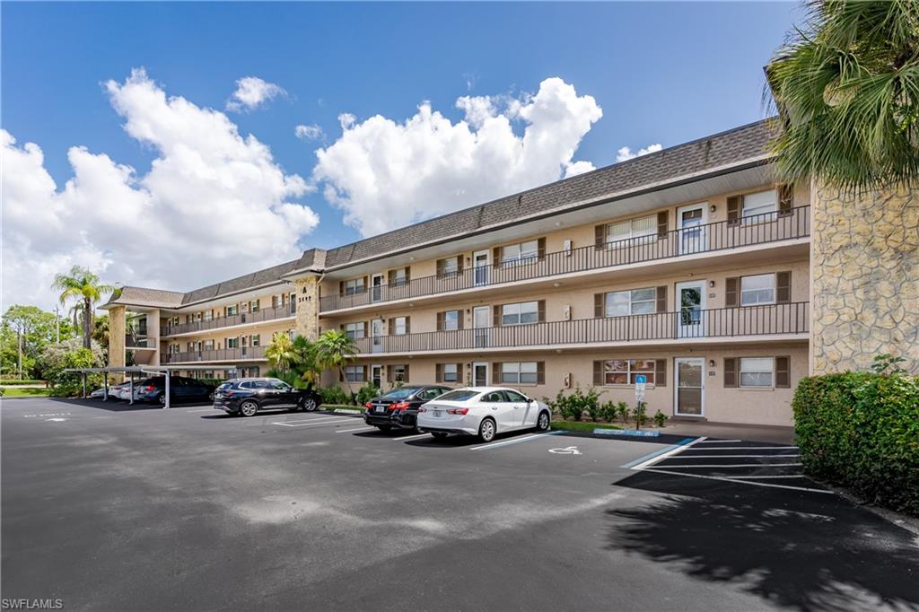 5499 Rattlesnake Hamm Road, Unit 304A Naples, FL 34113 - Photo 27 of 30 a front view of a building with street view