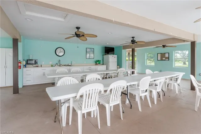 a view of a dining room with furniture and a clock