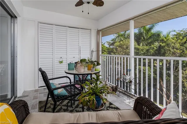 a view of a chairs and table in the balcony
