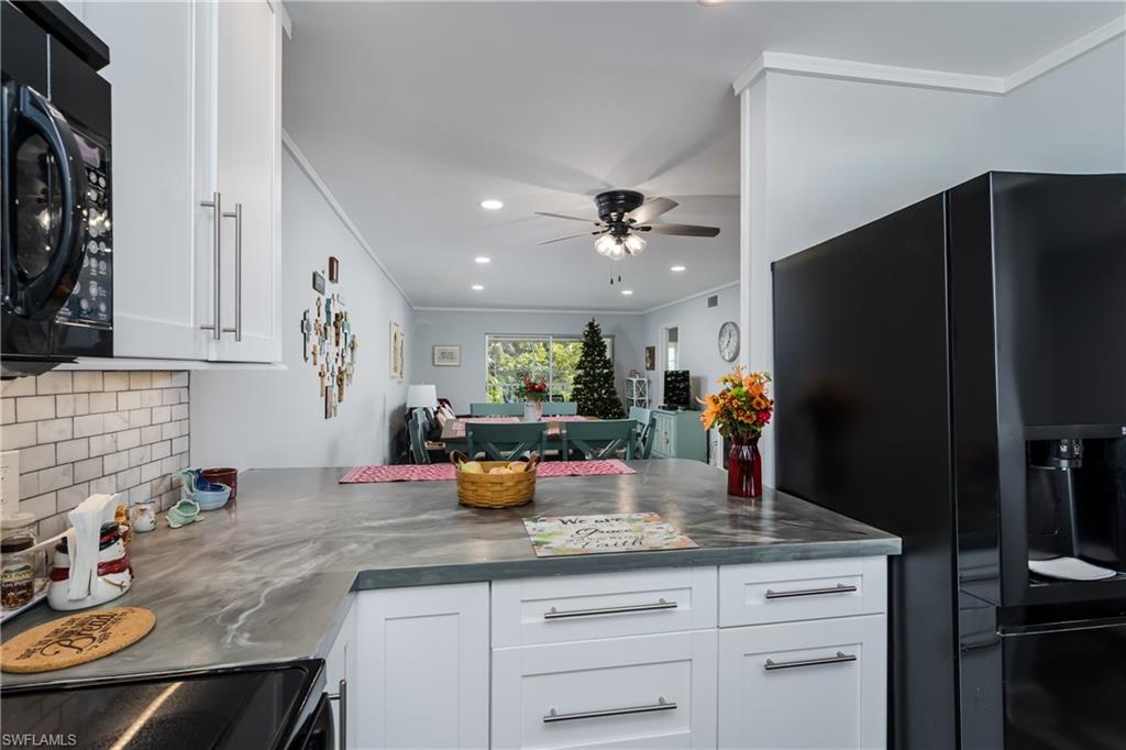 5499 Rattlesnake Hamm Road, Unit 304A Naples, FL 34113 - Photo 7 of 30 a kitchen with sink and refrigerator