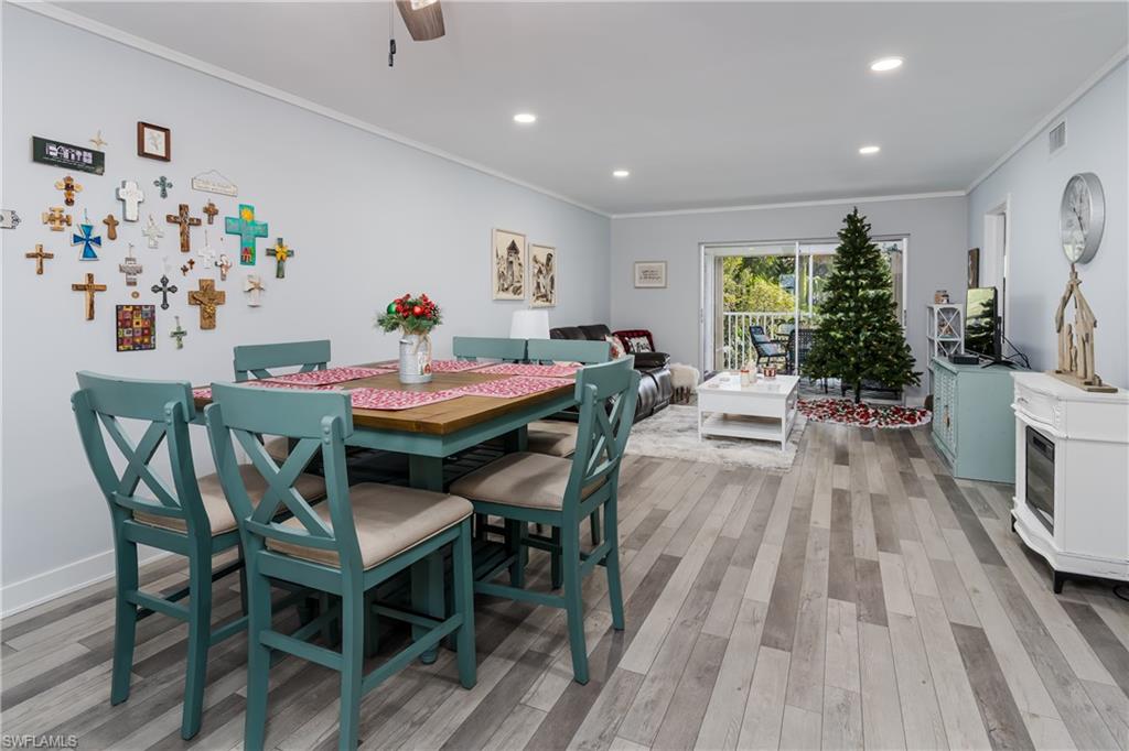 5499 Rattlesnake Hamm Road, Unit 304A Naples, FL 34113 - Photo 8 of 30 a view of a dining room with furniture and wooden floor