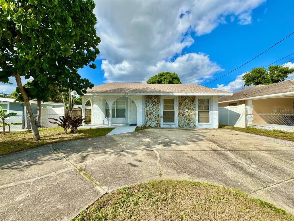 a view of a house with a yard and sitting area