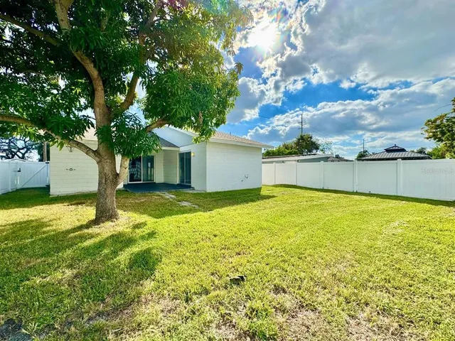 a view of a backyard with large trees