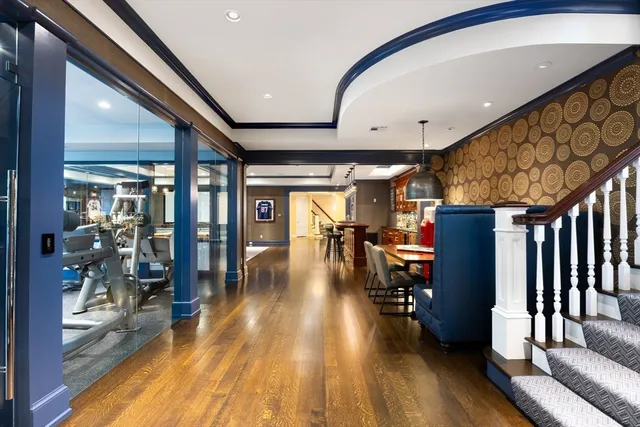 a view of a hallway with wooden floor and furniture