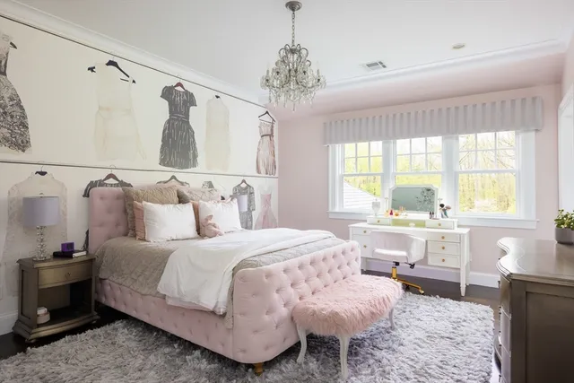 a bedroom with a bed and a chandelier