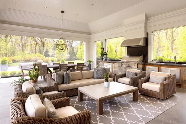 a living room with furniture a large window and a flat screen tv