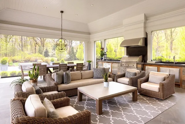 a living room with furniture a large window and a flat screen tv