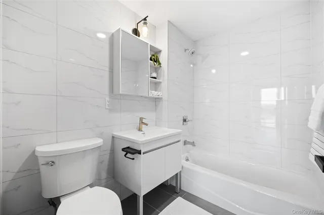 a bathroom with a sink toilet and bathtub