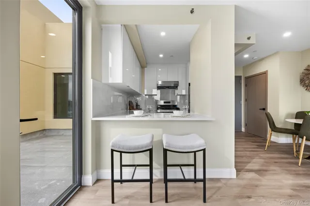 a kitchen with stainless steel appliances granite countertop a sink and a refrigerator
