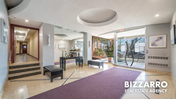 a lobby with furniture and floor to ceiling window