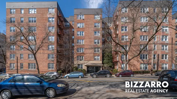 a front view of a building with parking space